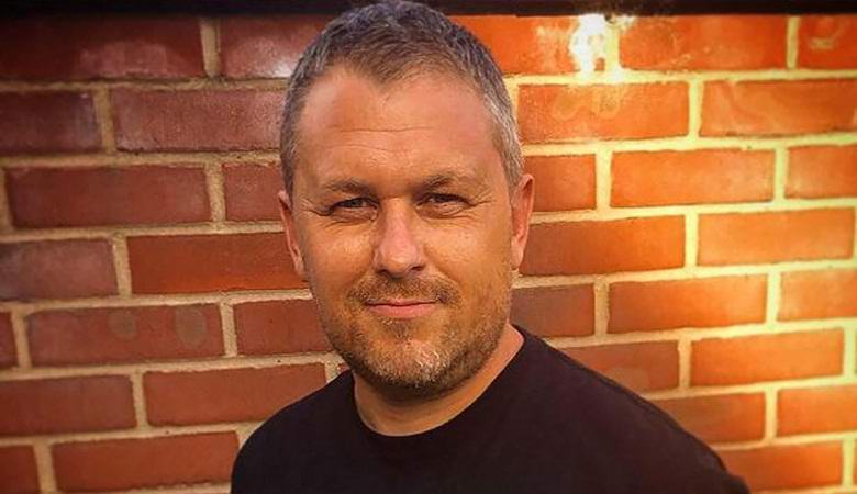 Mies kuvaa noidan henkeä roikkuvan puun kruunussa